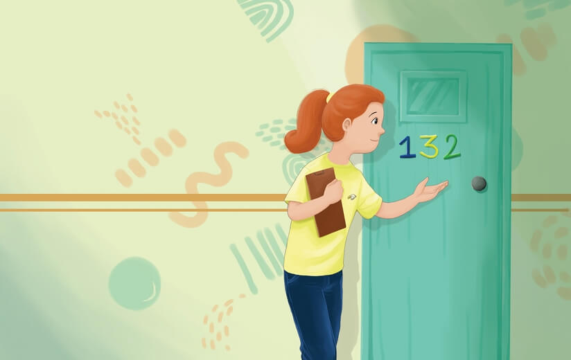 A teacher standing at the entrance of a classroom, ready to go in.