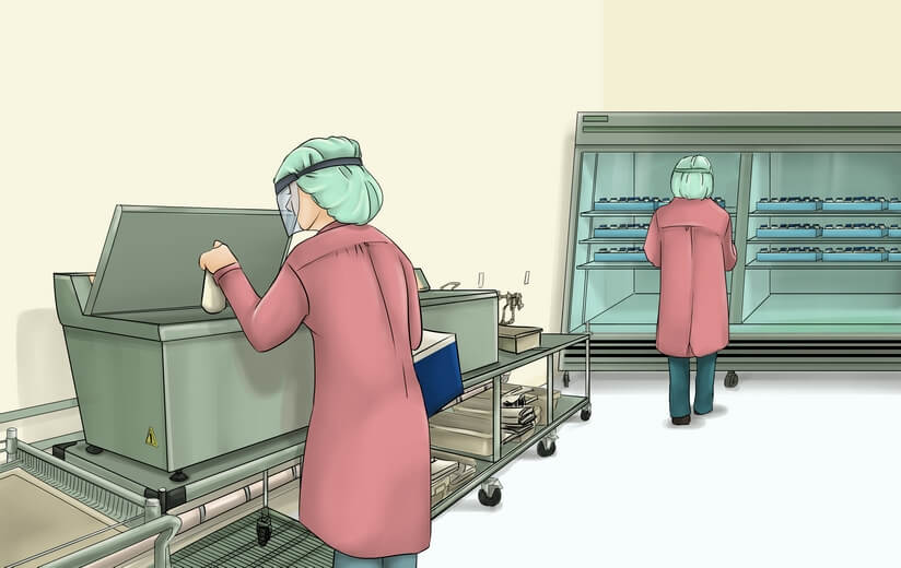 Workers in sterile gowns storing breast milk in cold storage.