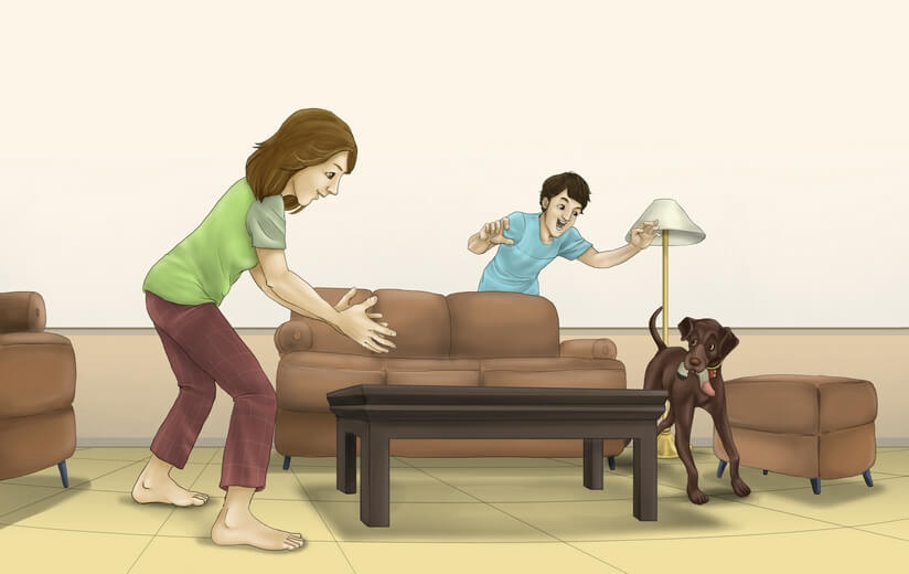 Dog owners playing catch with their dog in the living room.